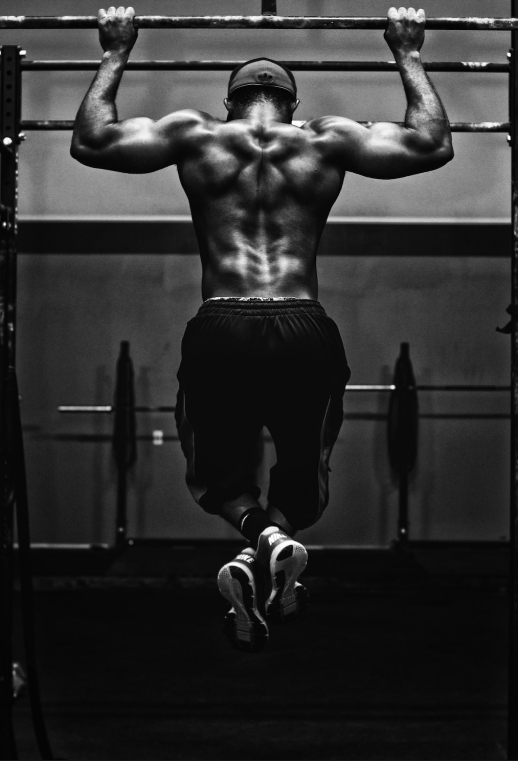 A man doing pull-ups on a horizontal bar